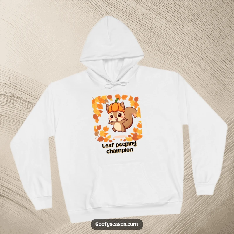 Funny hoodie with a playful squirrel in a pumpkin hat jumping through autumn leaves, offering cozy warmth and seasonal charm.
