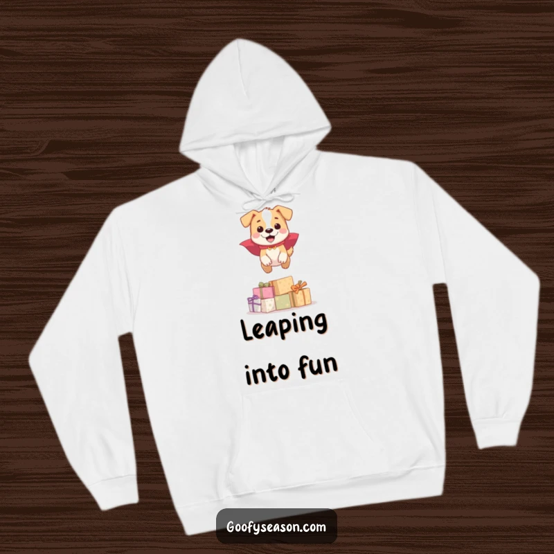 Funny happy dog in superhero cape, jumping over presents, on a cozy hoodie, a funny gift.