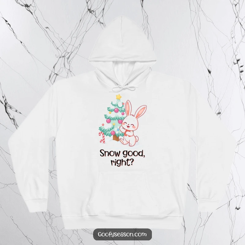 Funny bunny character decorating a snow-covered tree with candy, featured on a warm hoodie for festive winter fun.