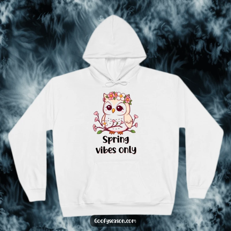Funny, cozy hoodie with a kawaii owl wearing a flower crown, looking at blooming spring buds.