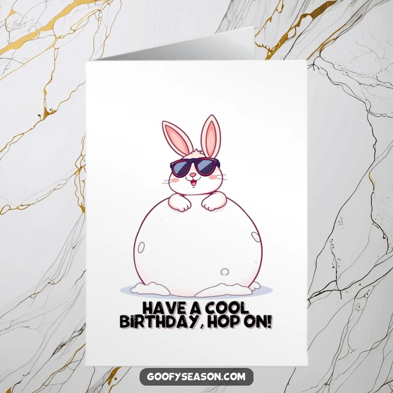 Funny Free Printable Birthday Card: Cheerful bunny in sunglasses lounging on a giant snowball, looking super cool.