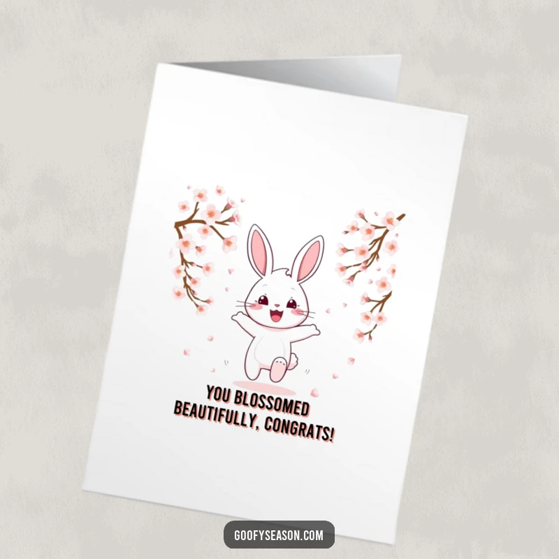 Funny Free Printable Bunny Congratulations Card: A happy bunny hops amongst falling cherry blossoms.