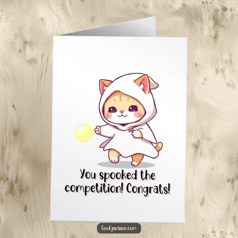 Free Printable Congratulations Card: A playful cat dressed as a ghost enthusiastically chases a bright, glowing orb, a mysterious celebration.