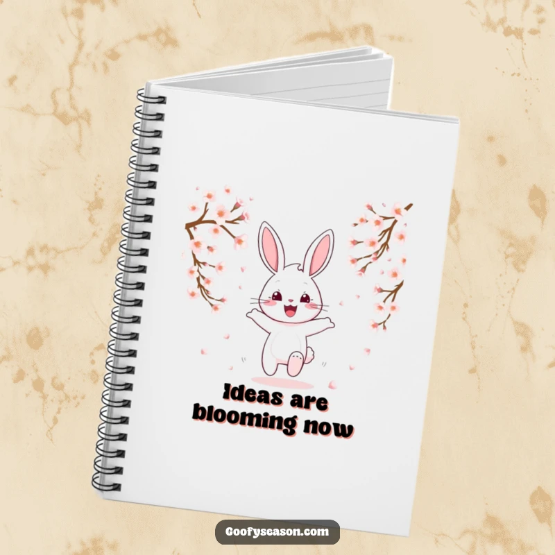 Funny happy bunny hopping through falling cherry blossoms on a notebook cover, spring stationery.