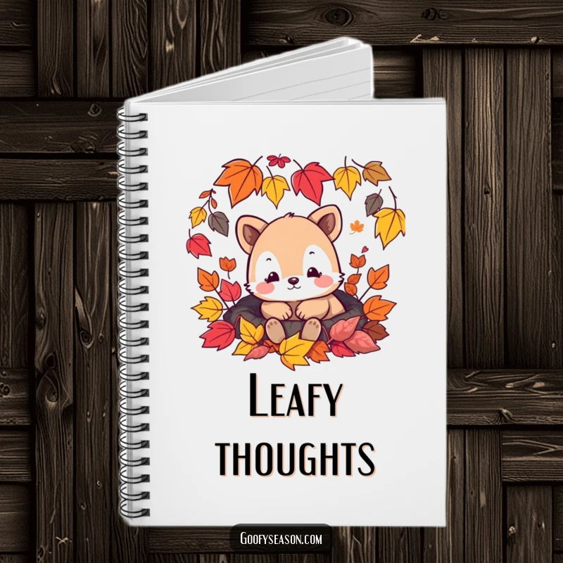 Funny notebook cover featuring a content animal character nestled among vibrant falling autumn leaves, perfect for journaling.