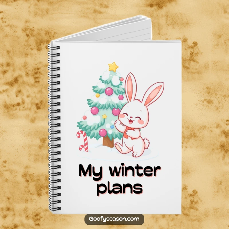 Funny bunny character decorating a snow-covered tree with candy, depicted on a notebook cover for jotting down holiday thoughts.
