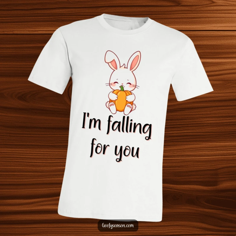 Funny Kawaii bunny with a shy smile holding a pumpkin, embodying autumn coziness on a soft graphic tee.