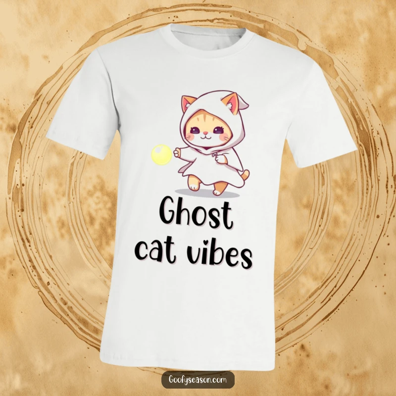 Funny cat in a ghost costume chasing a glowing orb on a t-shirt, a playful Halloween character.