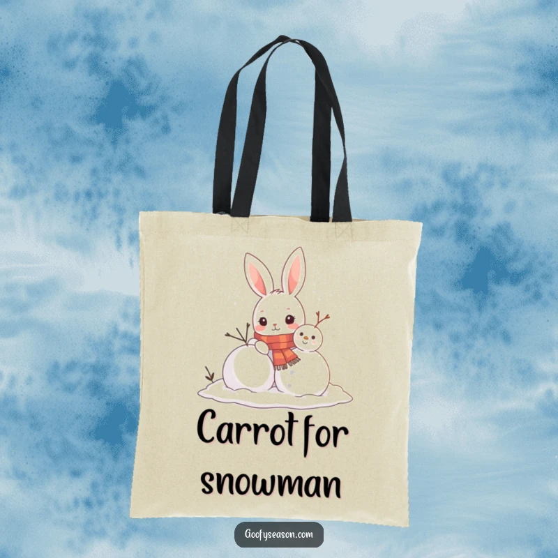 Funny tote bag showcasing a curious bunny in a scarf building a snowman, perfect for errands and carrying winter cheer.